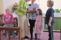 The children's group, Jigsaw, and leader Marie Maull present Jackie with leaving gifts.
