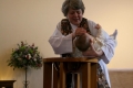The Rev'd Stefanie Hodges baptises Alexander.